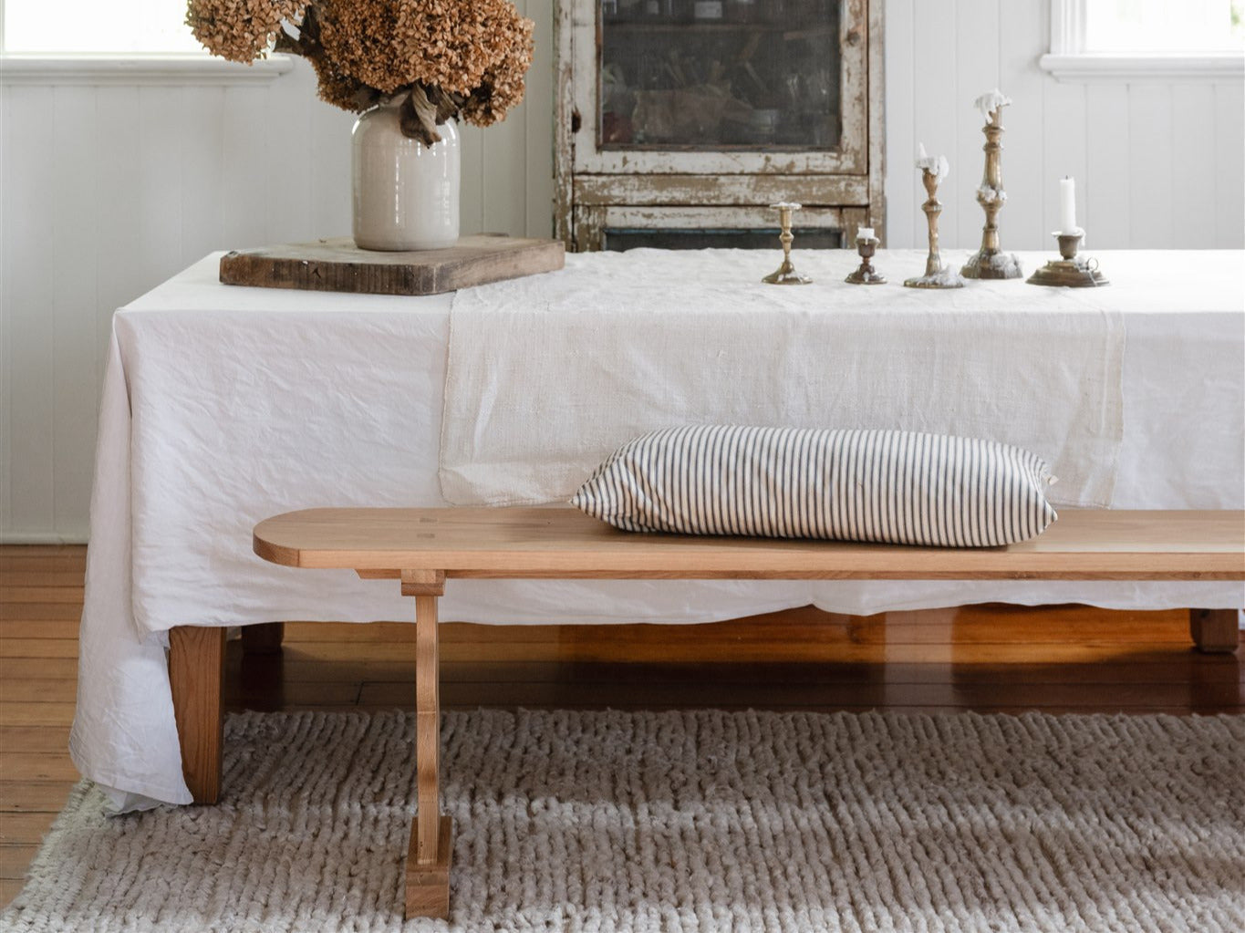French Bench in oak placed next to a farmhouse dining table